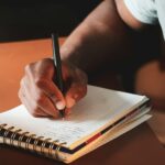 writing in notebook close-up hand - terrillo-walls-vq8vdVxFrtc-unsplash