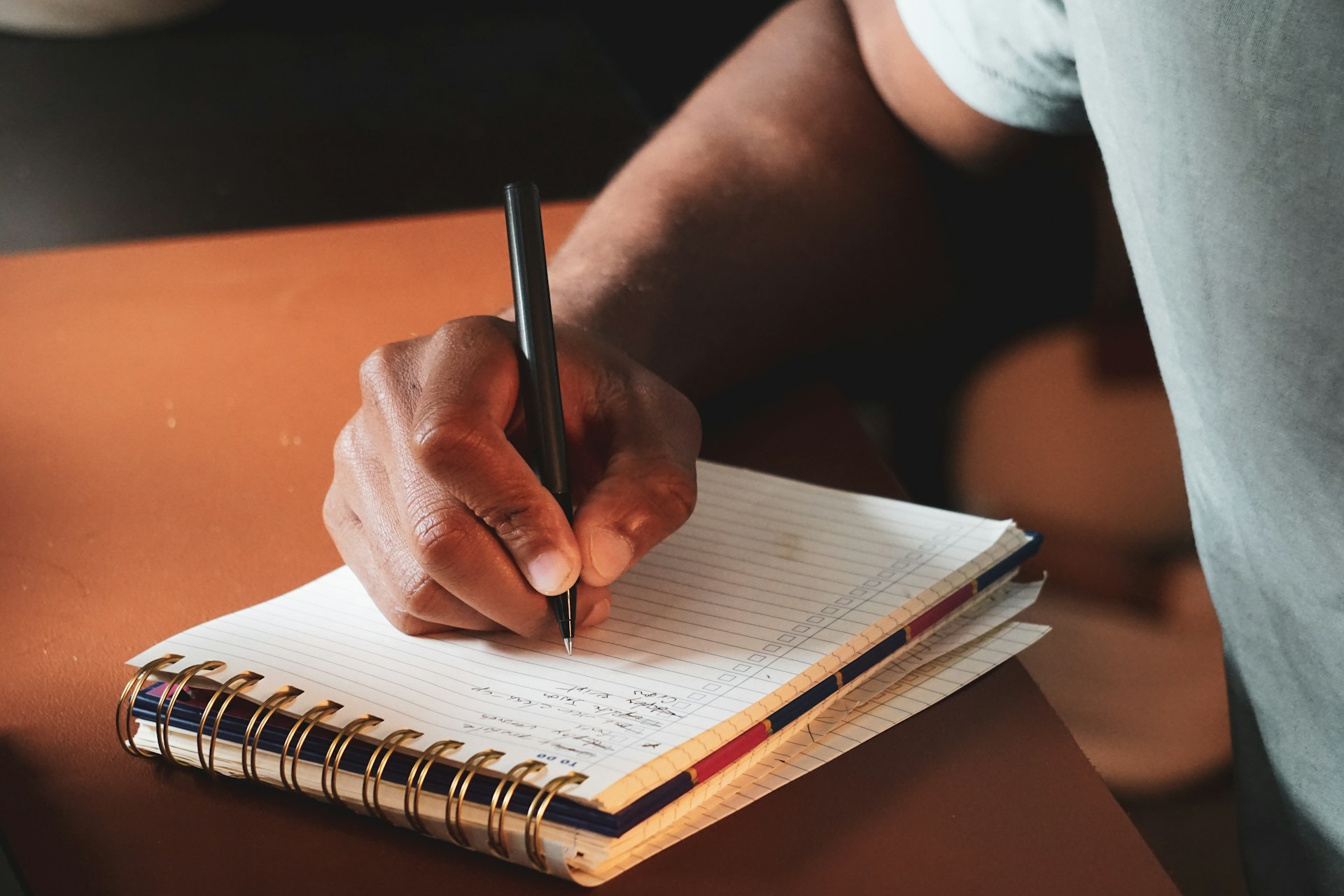 writing in notebook close-up hand - terrillo-walls-vq8vdVxFrtc-unsplash